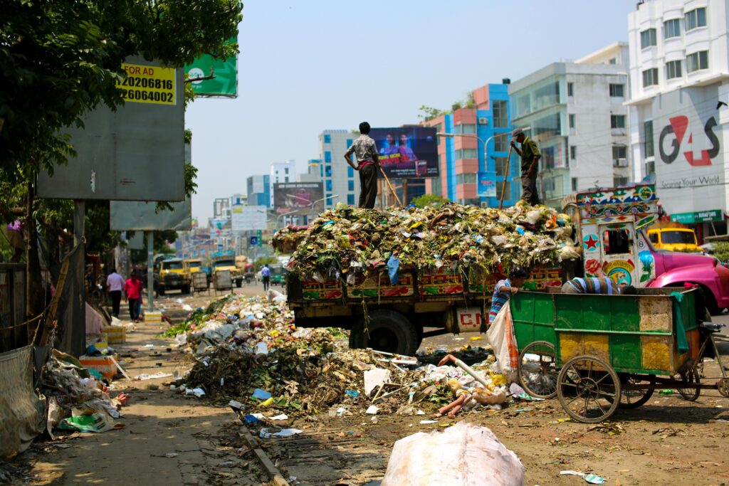 pexels-photo-2382894-2382894 Trash-filled streets with vibrant urban buildings in Bangladesh.