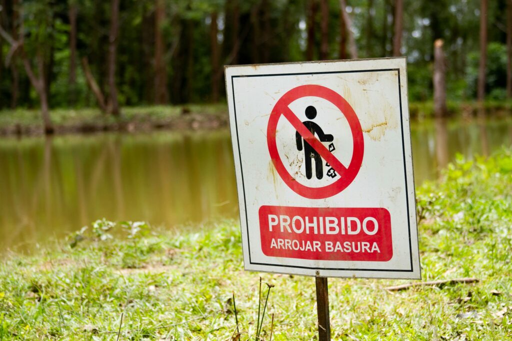 pexels-photo-5706280-5706280 Close-up of a no littering sign by a pond in a Colombian park.